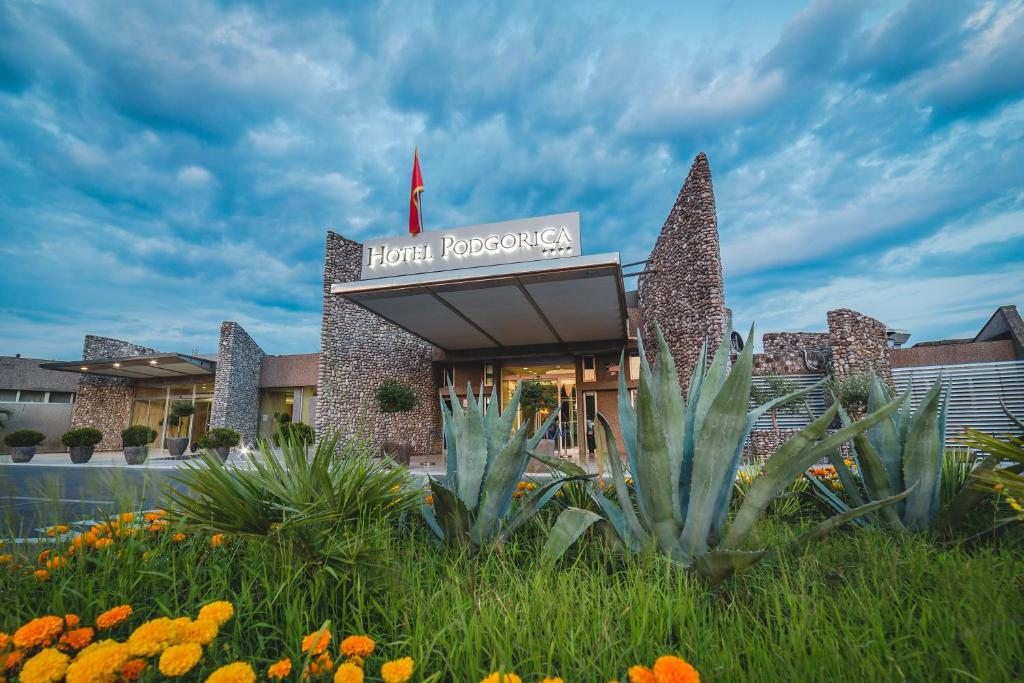 Hotel Podgorica entrance framed by agave plants and orange flowers