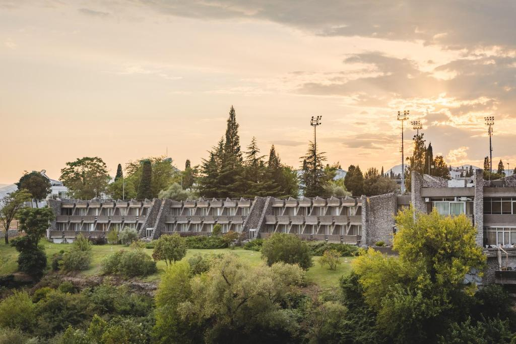 Long river-facing façade of Hotel Podgorica at sunset