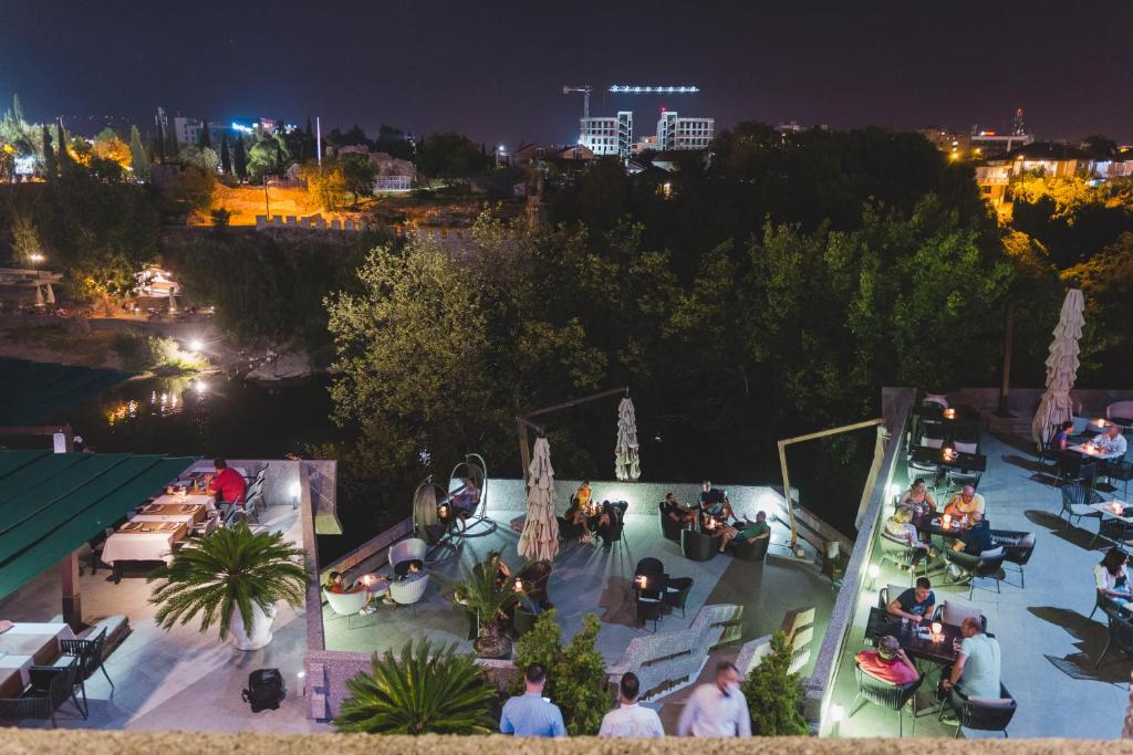 The hotel's restaurant terrace overlooking the river at night